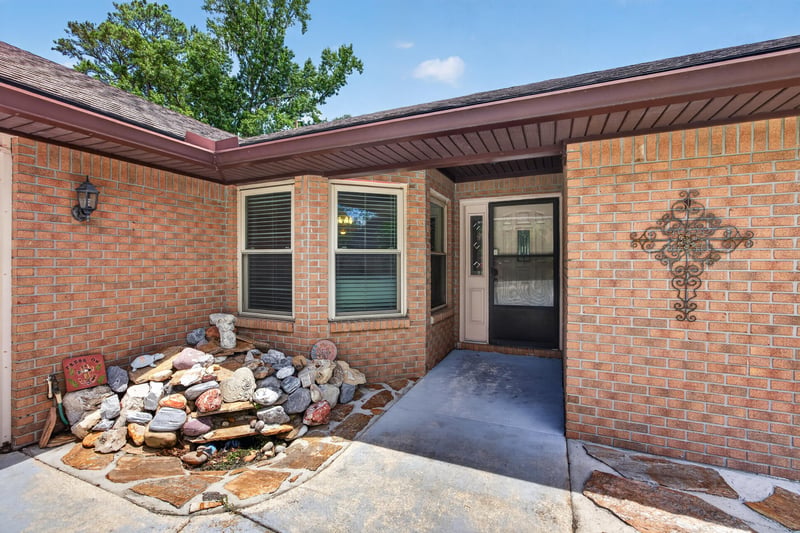 Covered front entry with decorative cross accent and brick columns at 2460 San Sago Ln, Jacksonville, FL