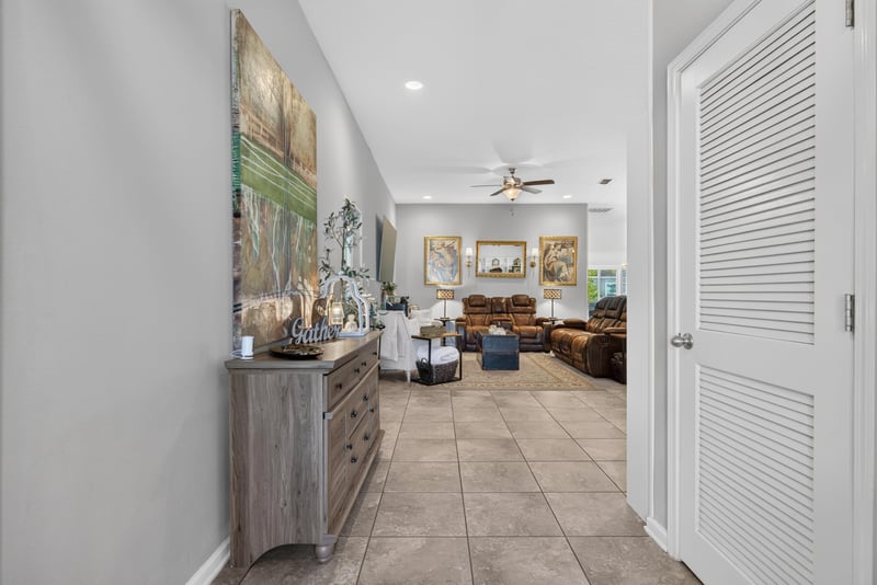 Entry foyer with console table and artwork at 589 Seville Pkwy, St. Augustine, FL