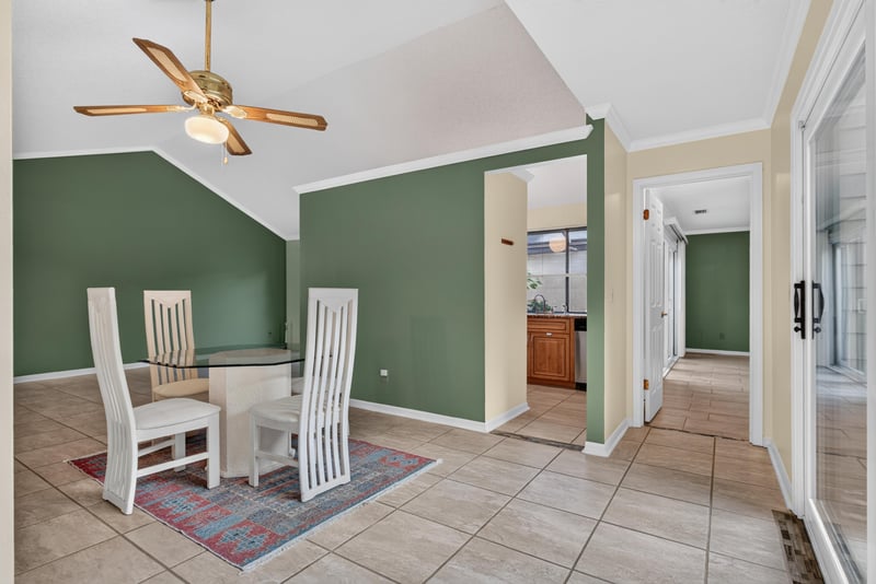Dining nook with green accent wall and chairs at 3515 Cormorant Branch Ct, Jacksonville, FL