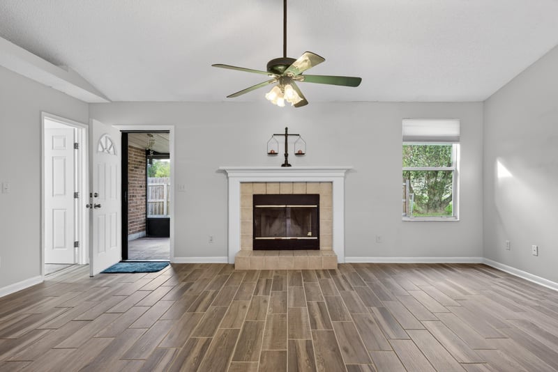 Living room with fireplace facing front entry at 2164 Orangewood St, Middleburg, FL 32068