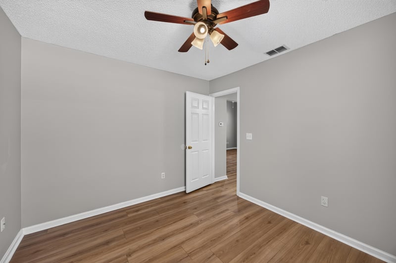 Bedroom with wood floor and closet doors at 9256 Dale View Ln W, Jacksonville, FL 32225
