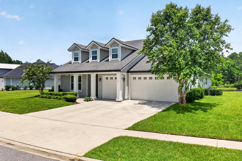 Front exterior straight-on view with dormer windows and driveway at 53 Lumen Ct, St. Augustine, FL 32095