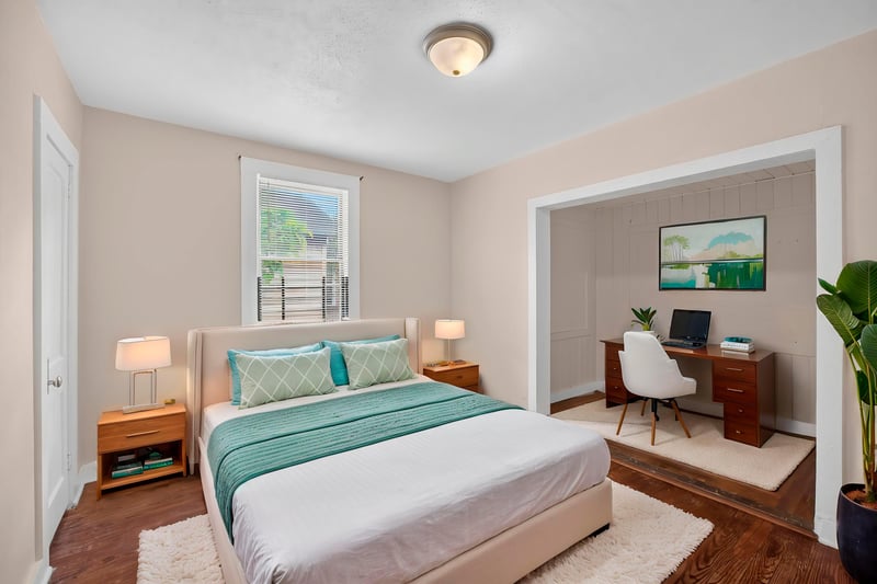 Virtually staged bedroom with bed and desk nook at 1473 State St W, Jacksonville, FL 32209