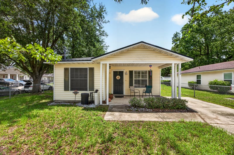 Front exterior with covered porch and yard at 5375 Dodge Rd, Jacksonville, FL 32209