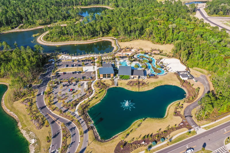 Aerial view of amenity center with parking and pond in St. Johns, FL