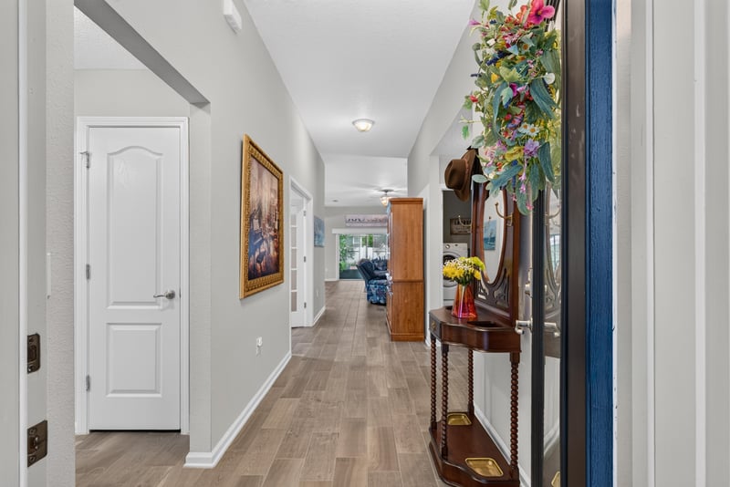 Entry hallway with wood-look flooring at 4319 Green River Pl, Middleburg, FL 32068