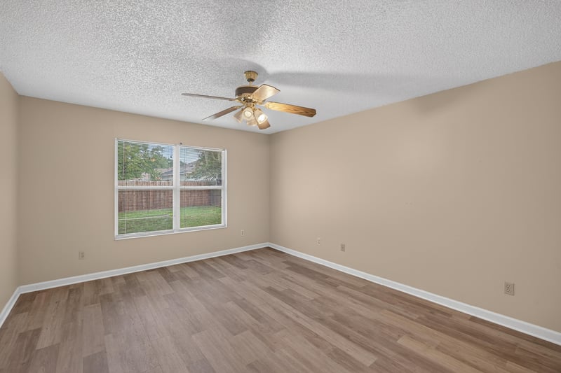 Bedroom with ceiling fan and window at 6646 Shiloh Creek Dr