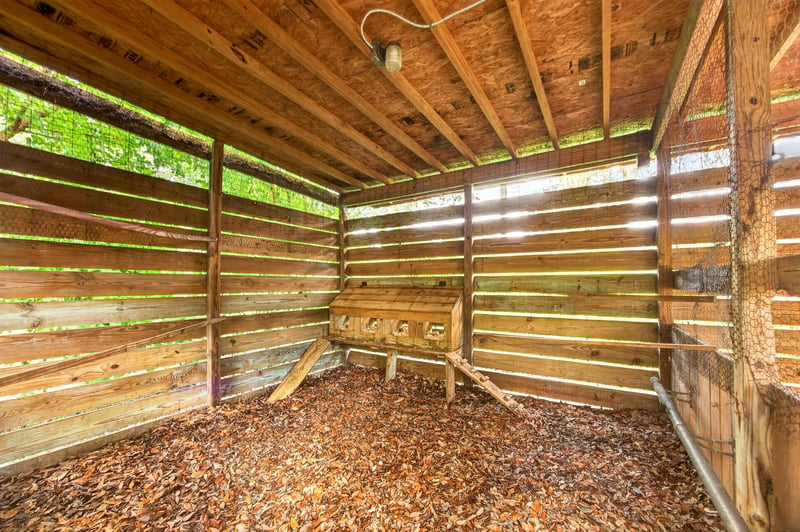 Barn stall interior with wood plank walls at 1161 Whispering Pines Rd, Jacksonville, FL 32259