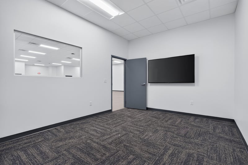 Empty room with wall-mounted monitor and interior door at 7240 Golden Wings Rd building 100, Jacksonville, FL 32244