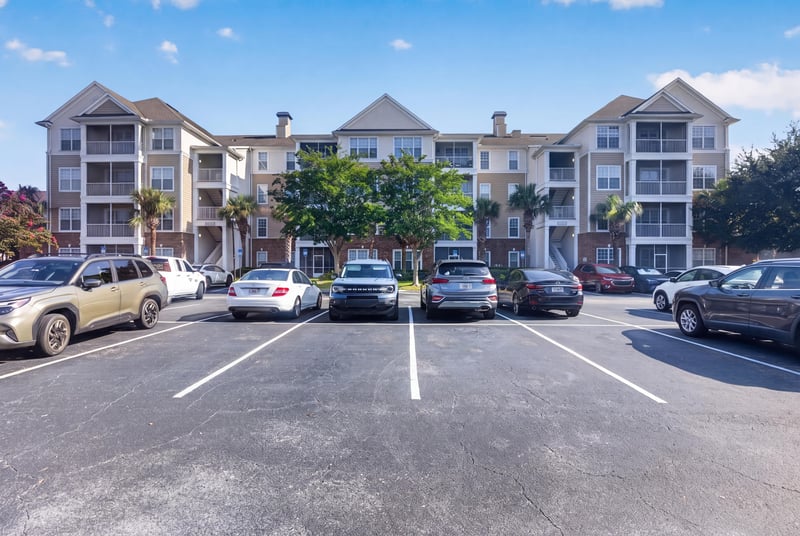 Condo building exterior and parking area at 11251 Campfield Dr unit 4209, Jacksonville, FL 32256