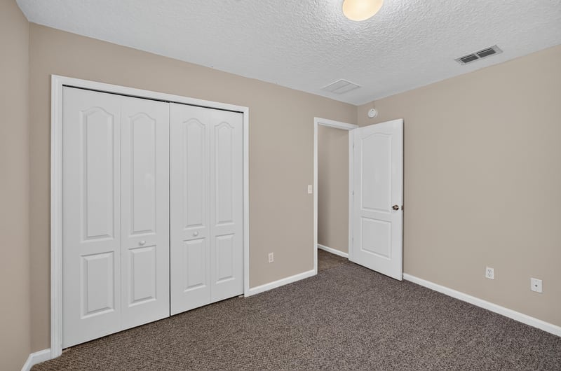 Carpeted bedroom with double closet doors at 469 Glendale Ln, Orange Park, FL