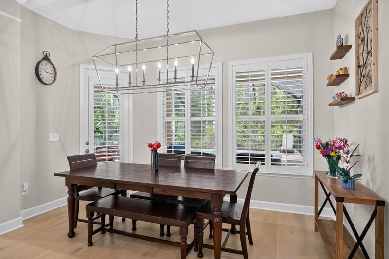 Dining area with wood table and linear chandelier at 276 Cross Ridge Dr, Ponte Vedra Beach, FL 32081