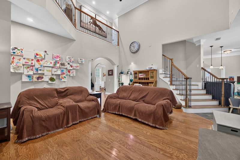 Great room with covered furniture and staircase at 1735 Hagans Ridge Ct