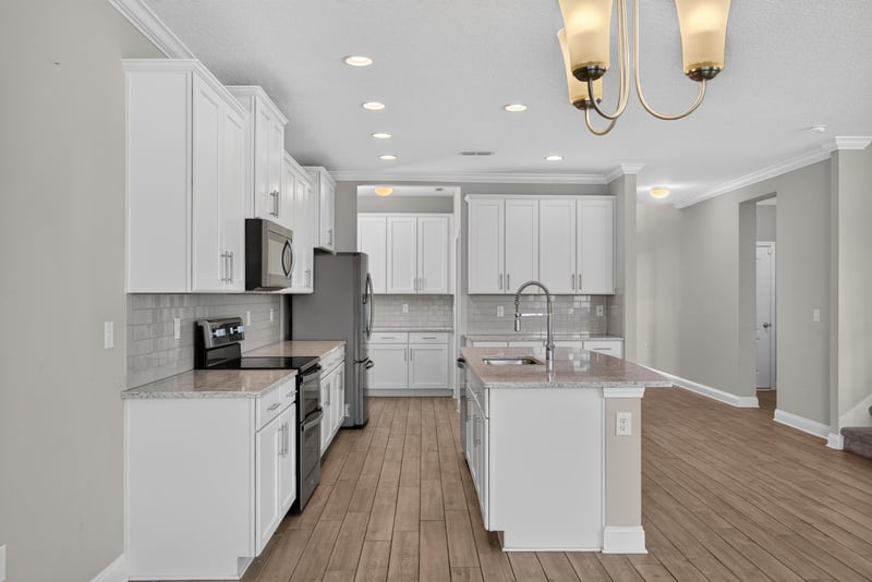 Kitchen with white cabinets and glass back door at 2580 Cold Stream Ln, Green Cove Springs, FL 32043