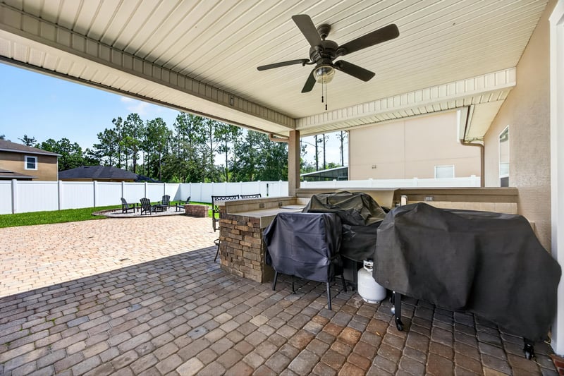 Covered patio with grills and ceiling fan at 3660 Middlebrook Dr, Orange Park, FL 32065
