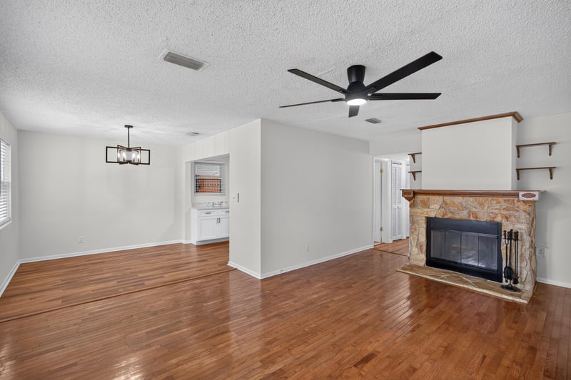 Living room with wood floors and stone fireplace at 4039 Habana Ave, Jacksonville, FL