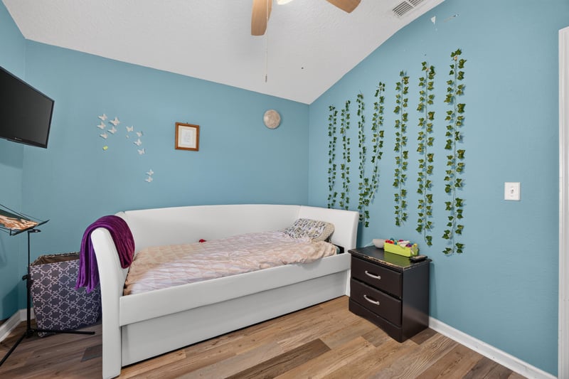 Bedroom with blue walls and wall decor at 2065 Creekmont Dr