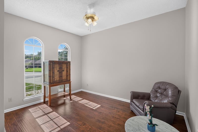 Entry sitting area with arched windows and wood floor at 11828 Heather Grove Ln, Jacksonville, FL