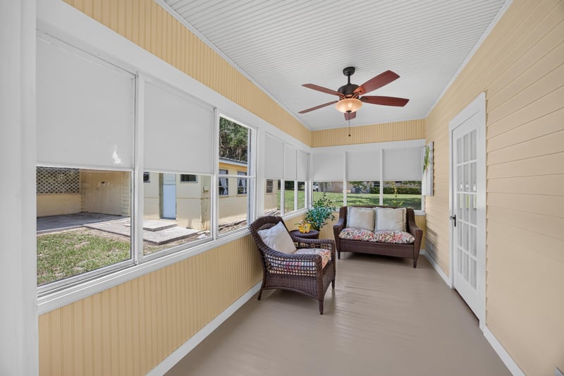 Sunroom with French doors and seating at 101 N Lake St, Crescent City, FL