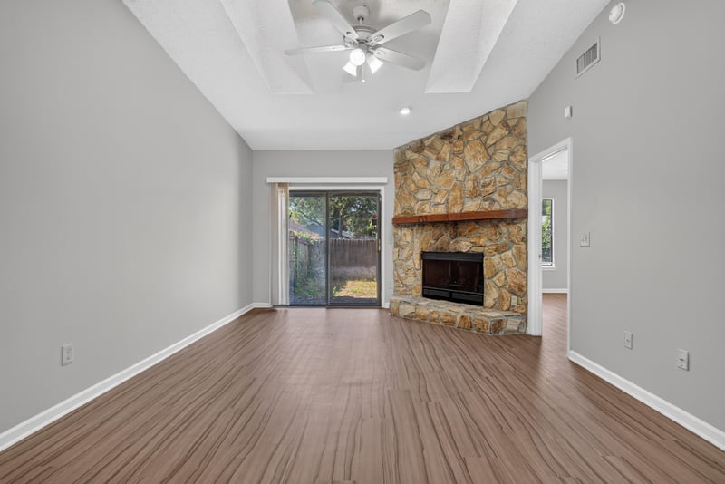 Living room with sliding glass door to backyard at 8010 International Village Dr, Jacksonville, FL 32277