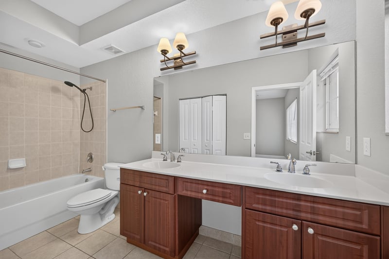 Bathroom with double vanity and tub-shower combo at 9745 Touchton Rd, Jacksonville, FL 32246