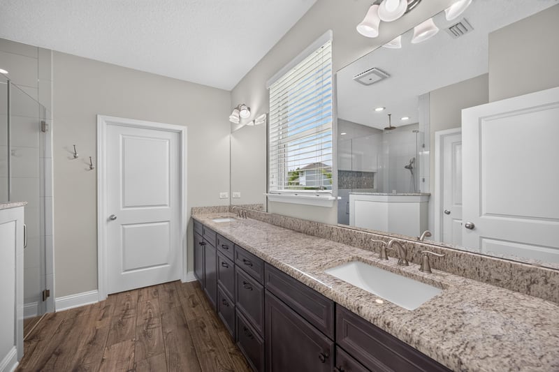 Bathroom with double vanity and wood flooring at 53 Lumen Ct, St. Augustine, FL 32095