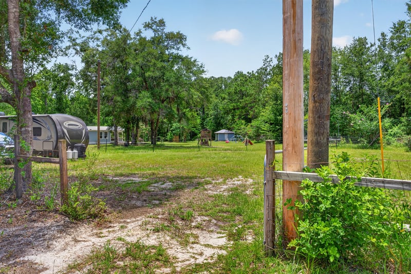 Yard area with utility pole and trees at 4890 McAllister Rd, Middleburg, FL 32068