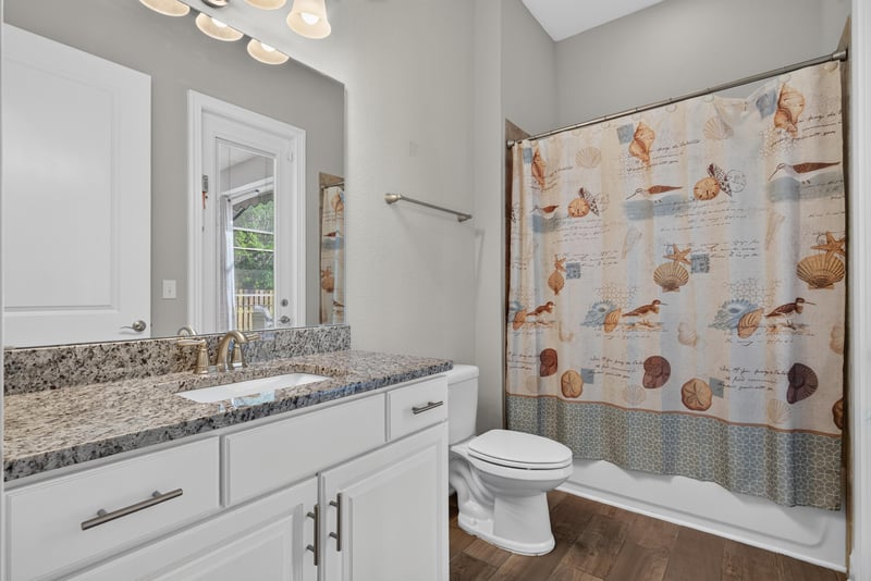 Bathroom vanity with shower curtain at 3328 Southern Oaks Dr, Green Cove Springs, FL 32043