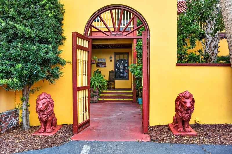 Courtyard entrance with lion statues and an arched gate at 115 Cordova St, St. Augustine, FL