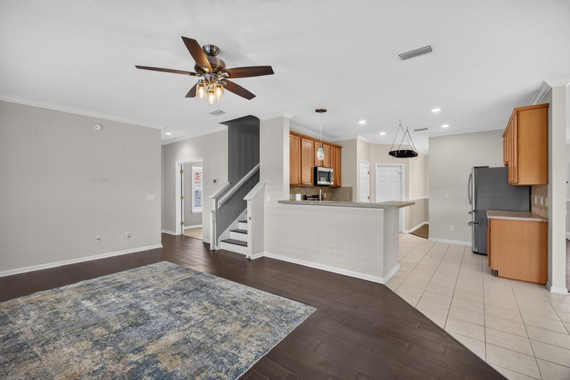 Family room open to the kitchen with ceiling fan at 1493 Greyfield Dr, St. Augustine, FL 32092