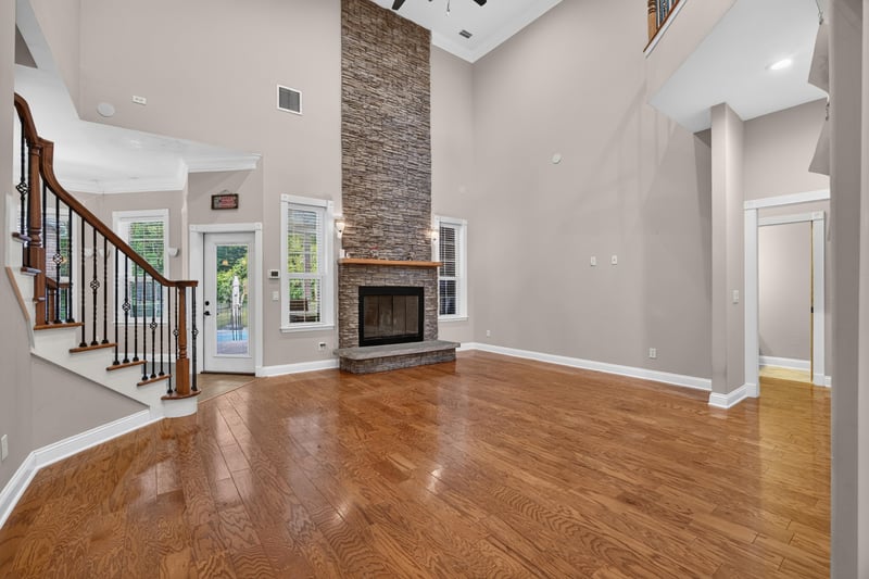 Great room with stone fireplace and staircase at 1735 Hagans Ridge Ct