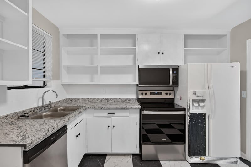Kitchen with white cabinets and checkered floor at 6338 Mercer Cir W, Jacksonville, FL