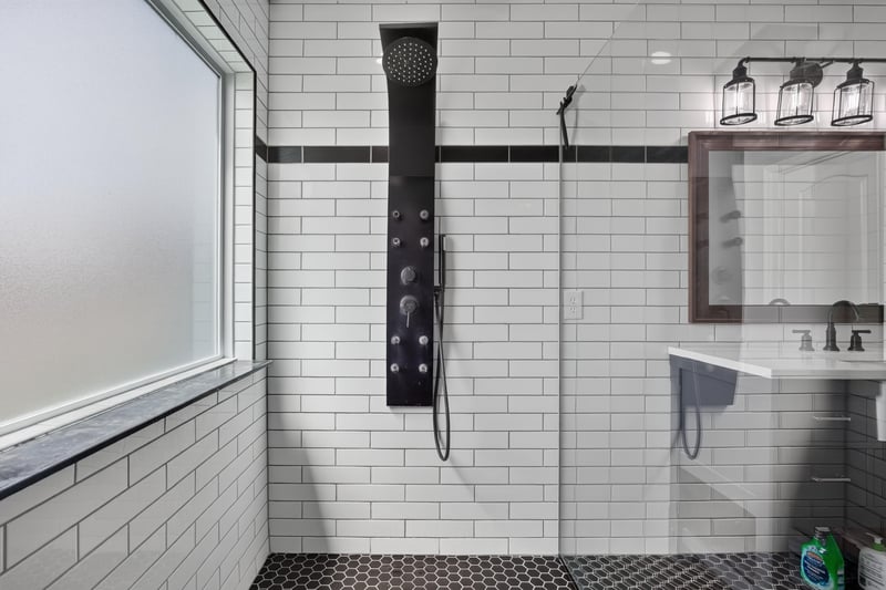 Primary bathroom shower with multiple fixtures at 2065 Creekmont Dr