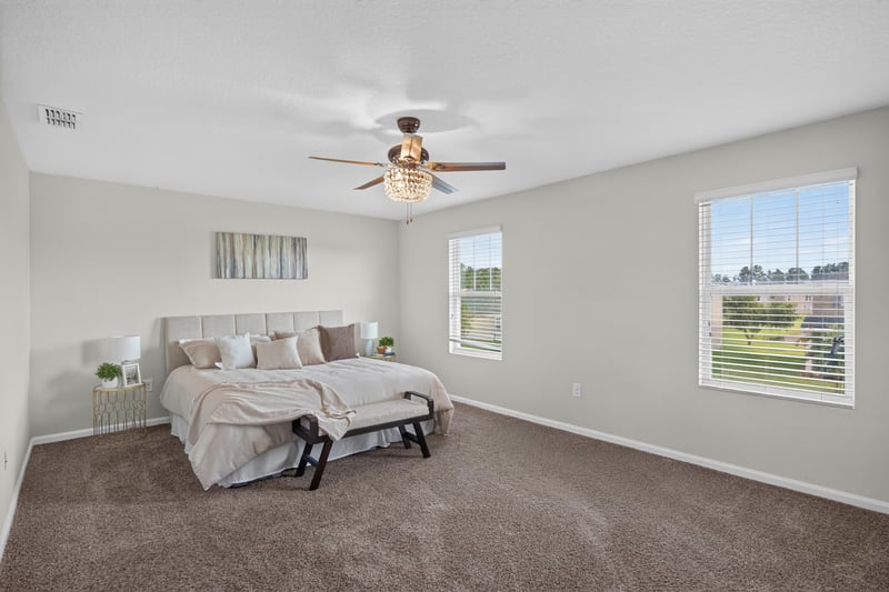 Primary bedroom with ceiling fan and carpet at 6830 Hanford St, Jacksonville, FL 32219
