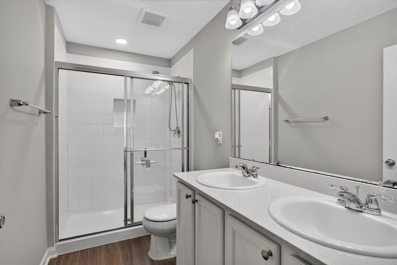Bathroom with glass shower stall and dual sink vanity at 7118 Preston Pnes Trl, Jacksonville, FL