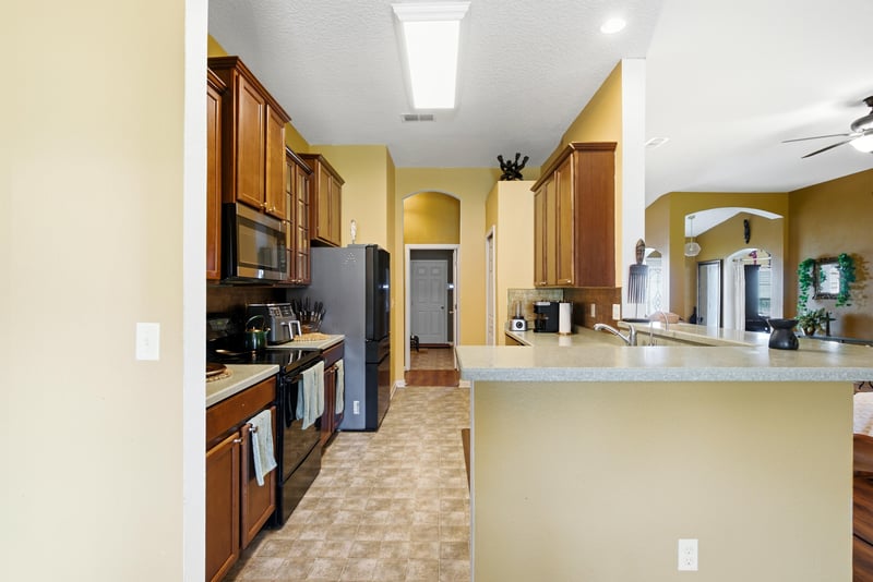 Kitchen with breakfast bar and black refrigerator at 7392 Timber Falls Ct