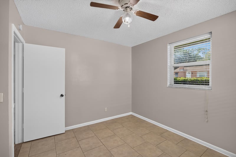 Bedroom with window and ceiling fan at 8067 Parental Cir, Jacksonville, FL 32216