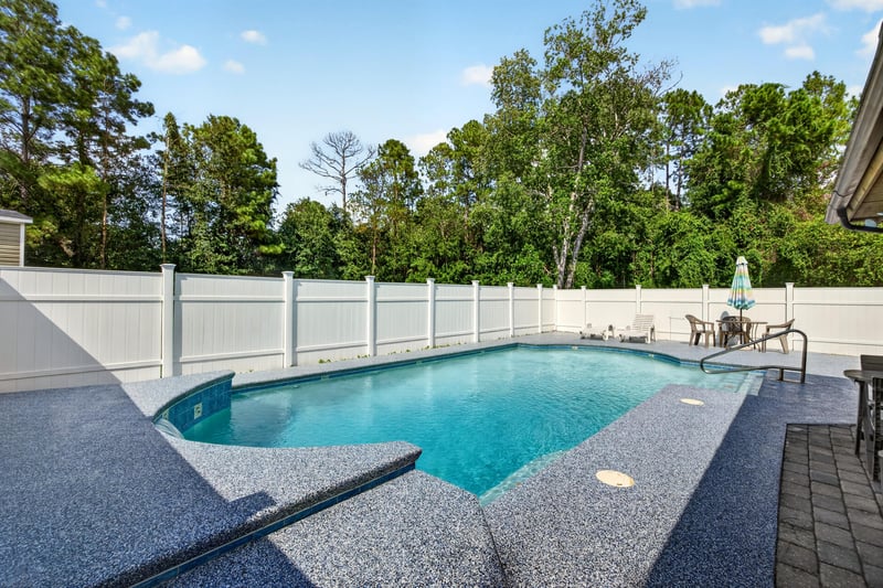 In-ground pool with gravel deck and patio furniture at 2435 Range Line Rd, Middleburg, FL