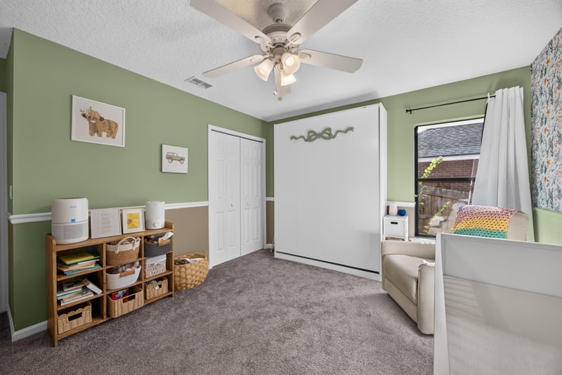 Bedroom with green walls and chalkboard wall at 2125 Blue Heron Cove Dr, Orange Park, FL 32003