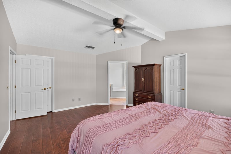 Primary bedroom with door to bath at 11828 Heather Grove Ln, Jacksonville, FL