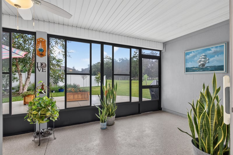 Sunroom with tile floor and large windows at 4319 Green River Pl, Middleburg, FL 32068