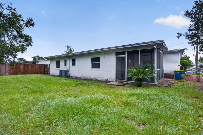 Backyard view with screened porch at 11462 Elane Dr, Jacksonville, FL