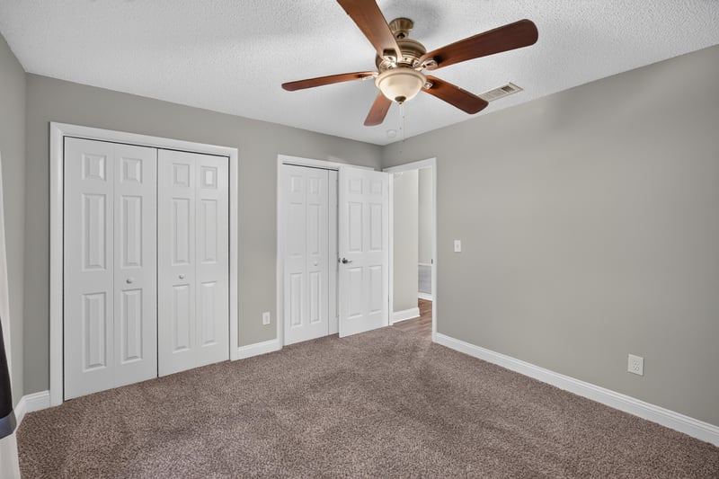 Carpeted bedroom with double closet at 12344 Cormorant Ct, Jacksonville, FL
