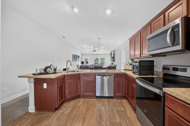 Kitchen view with microwave and tile backsplash at 9846 Olivia St, Jacksonville, FL