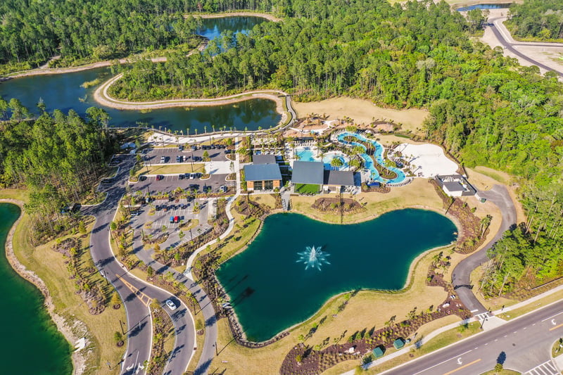 Aerial view of pool complex and lake in St. Johns, FL