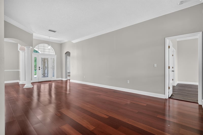Living room with arched doorway and wood floors at 4109 Eagle Landing Pkwy, Orange Park, FL 32065