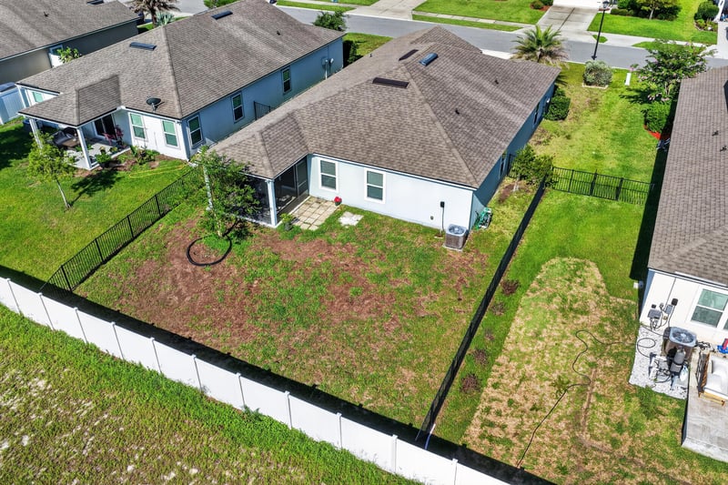 Aerial backyard view with fenced yard at 589 Seville Pkwy, St. Augustine, FL