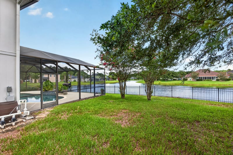 Screened lanai and backyard with lake view at 1493 Greyfield Dr, St. Augustine, FL 32092