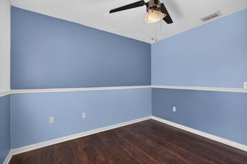 Bedroom with periwinkle walls and wood floor at 3428 Glenn Hollow Ct, Jacksonville, FL 32226