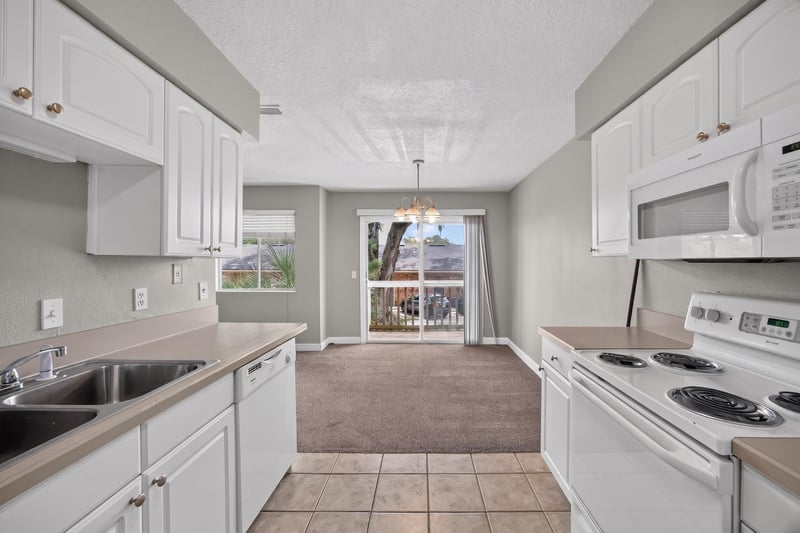 Kitchen sink and view into dining area at 1800 Park Ave apt 358, Orange Park, FL